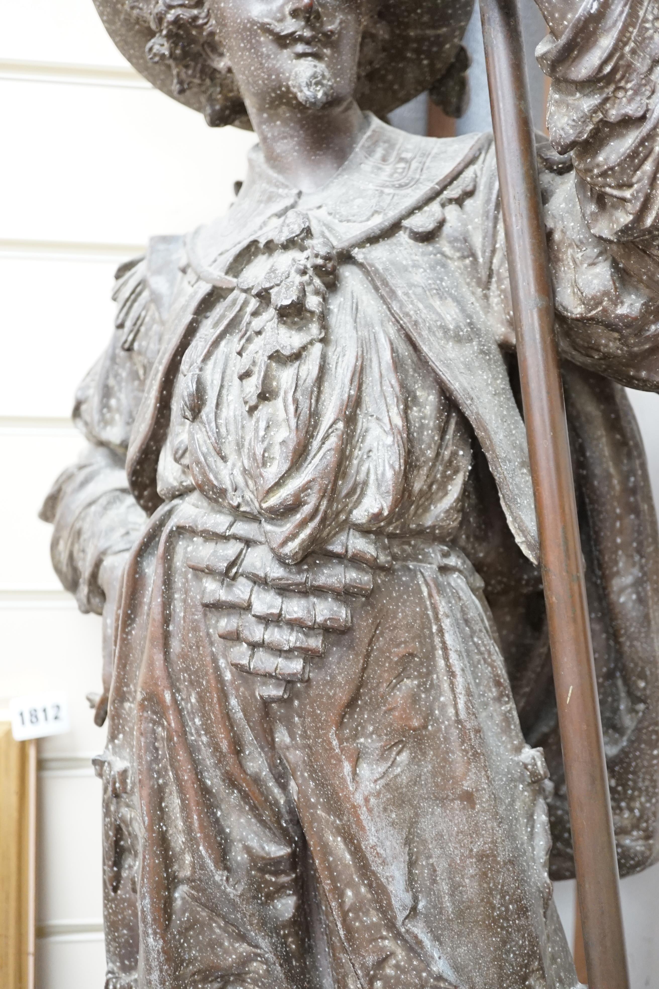 A 20th century spelter figural Cavalier floor lamp, with glass torch shade, approximately 108cm high